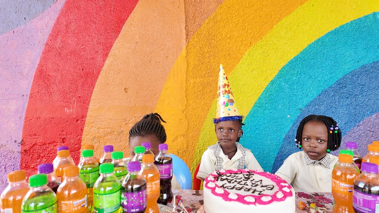 Children celebrate with a birthday cake.