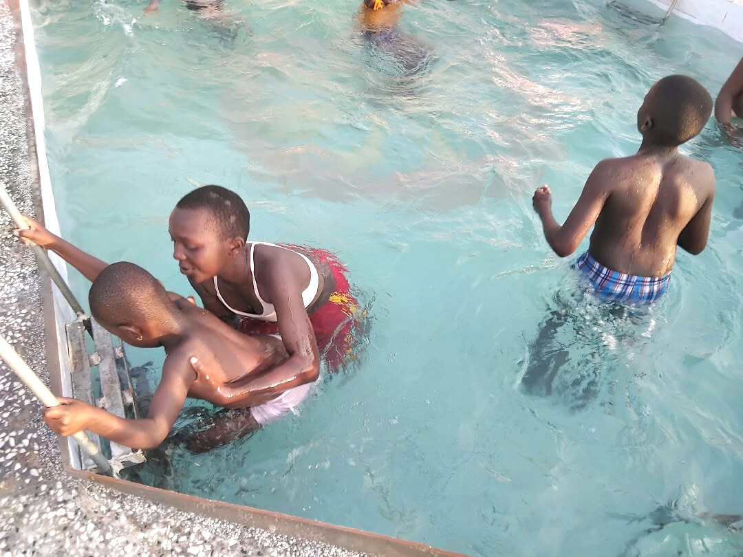 Children enjoy time in a swimming pool.